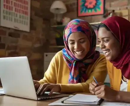 Two happy women studying